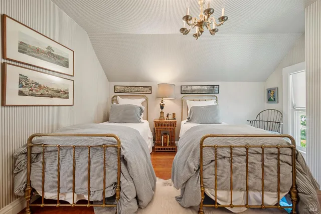 a living room with furniture and a wall painting