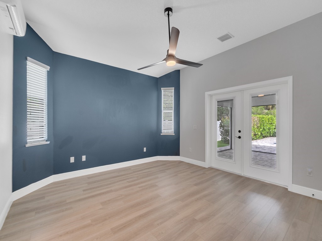 431 Midvale Terrace Sebastian, FL 32958 - Photo 18 of 34 a view of an empty room with window and wooden floor