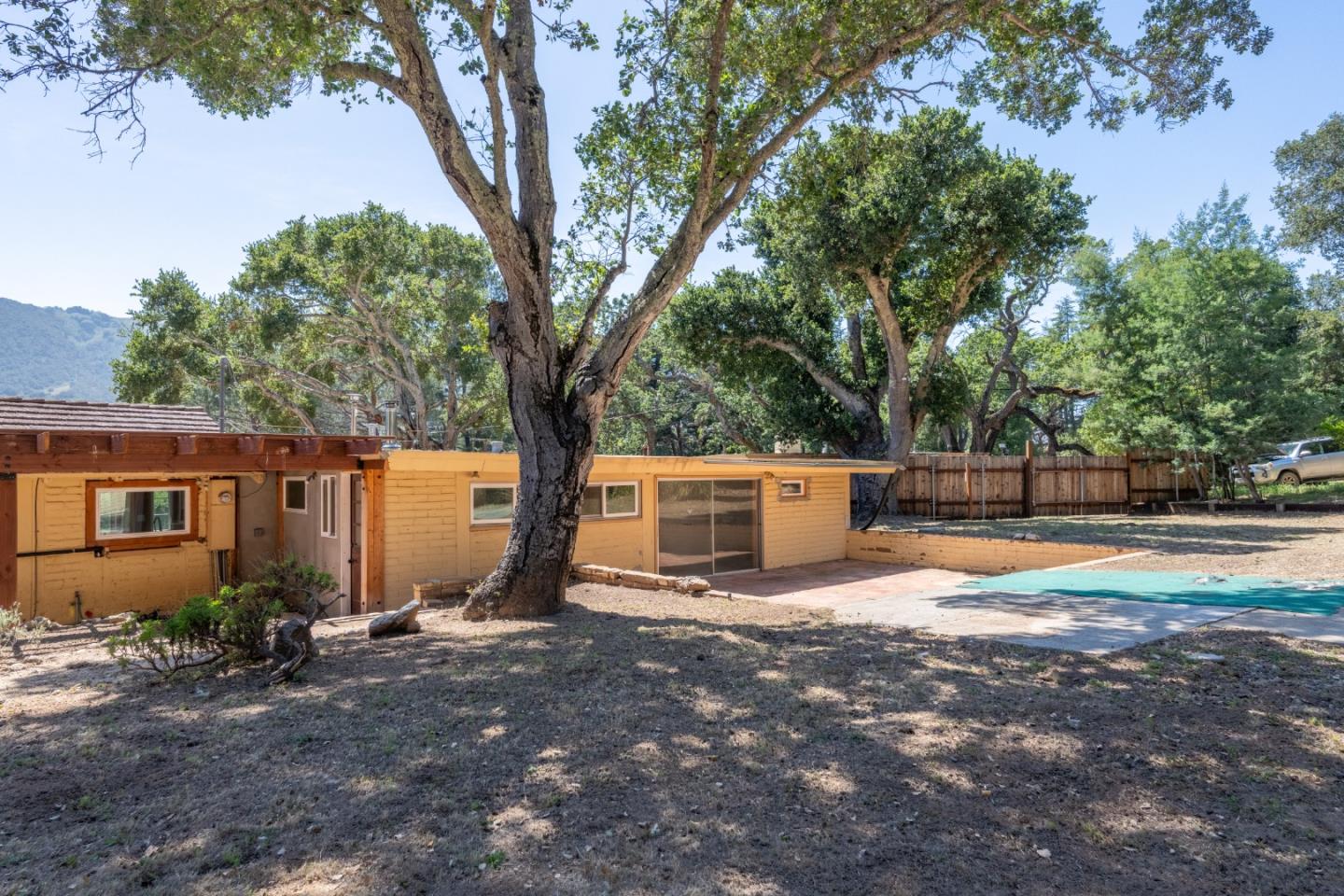 72 Los Laureles Grade Road Carmel Valley, CA 93924 - Photo 31 of 43 a view of a house with backyard and tree