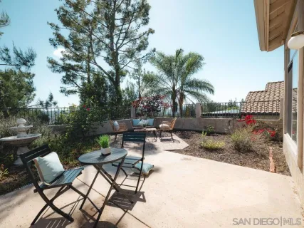 a view of a backyard tables and chairs with swimming pool