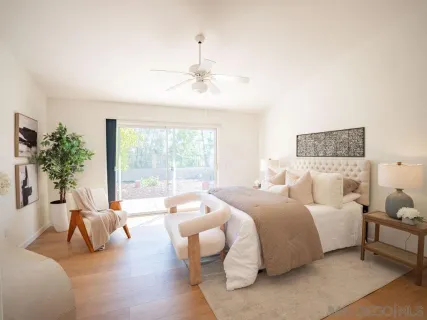 a spacious bedroom with a bed and a large window