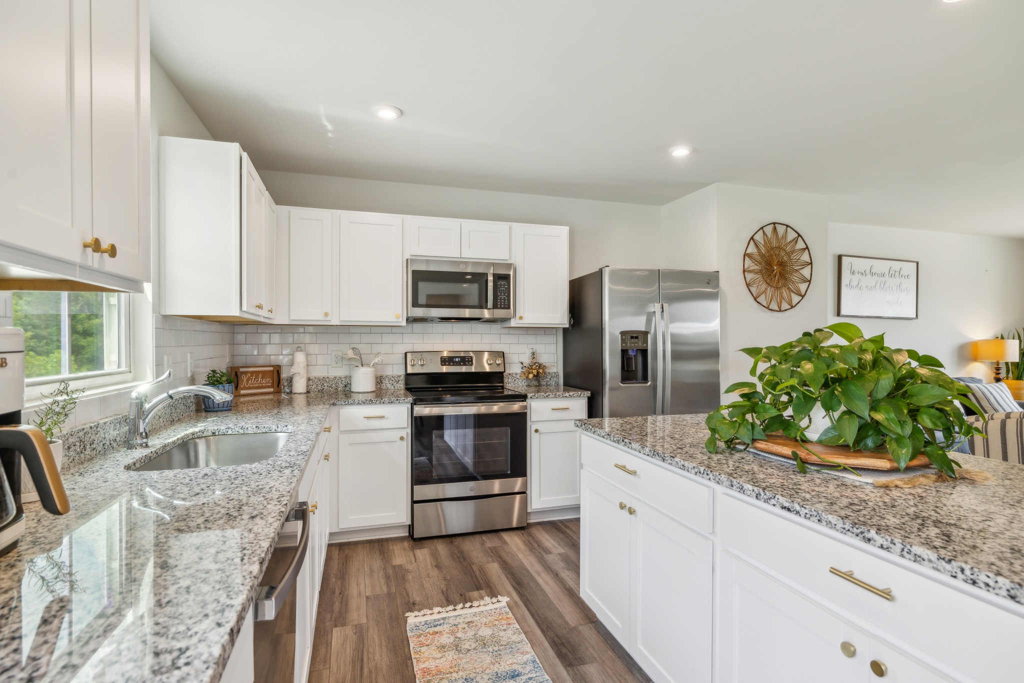 1718 Quail Run Way Spring Hill Spring Hill, TN 37174 - Photo 12 of 40 a kitchen with granite countertop a sink and stainless steel appliances