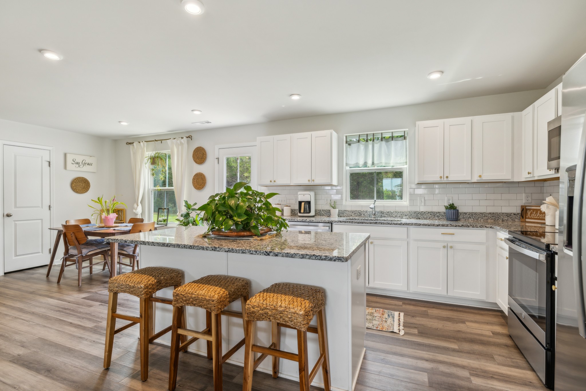 1718 Quail Run Way Spring Hill Spring Hill, TN 37174 - Photo 10 of 40 a kitchen with granite countertop white cabinets and stainless steel appliances