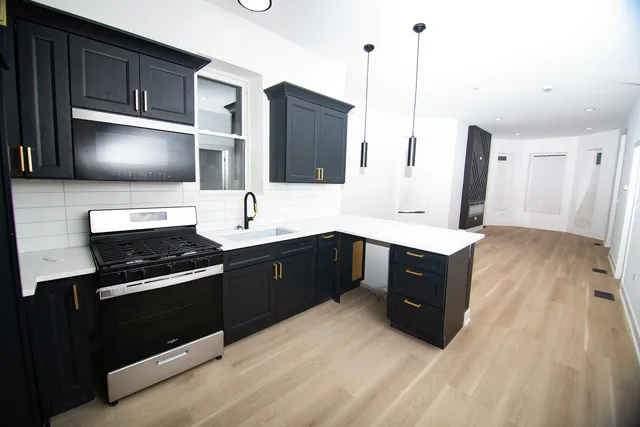 a kitchen with a sink stove and microwave