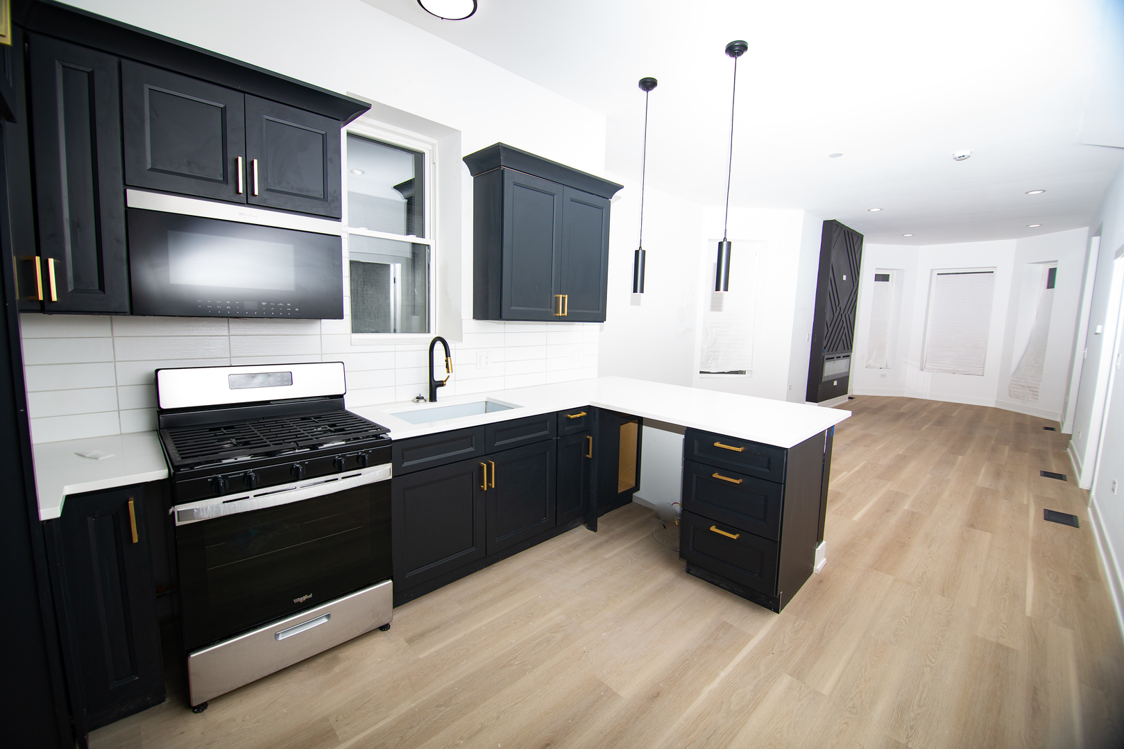 5531 South May Street Chicago, IL 60621 - Photo 5 of 11 a kitchen with a sink stove and microwave