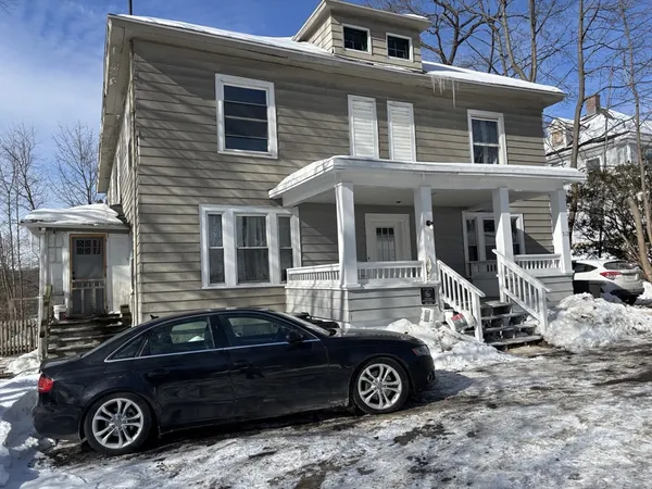 a car parked in front of a house
