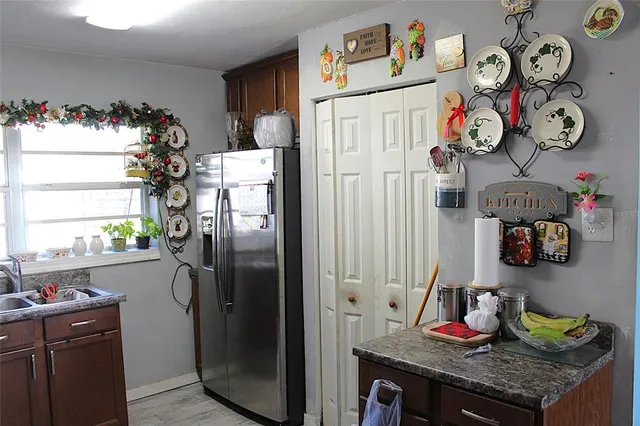 a kitchen with a refrigerator and a stove top oven