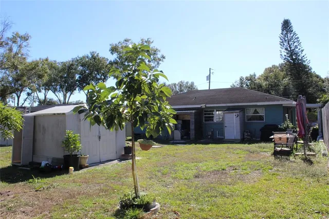 a view of a house with a yard and sitting area