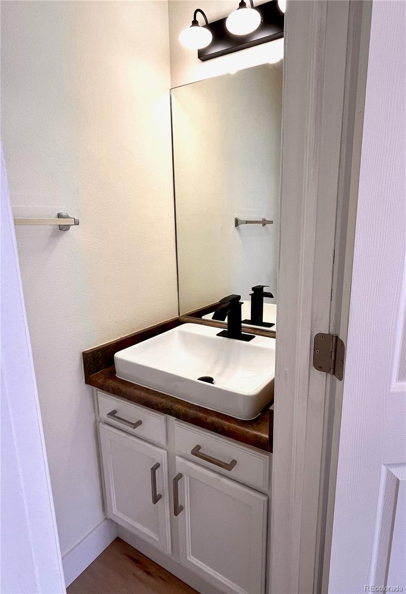 4660 Skylark Road Colorado Springs, CO 80916 - Photo 12 of 33 a bathroom with a sink and a mirror