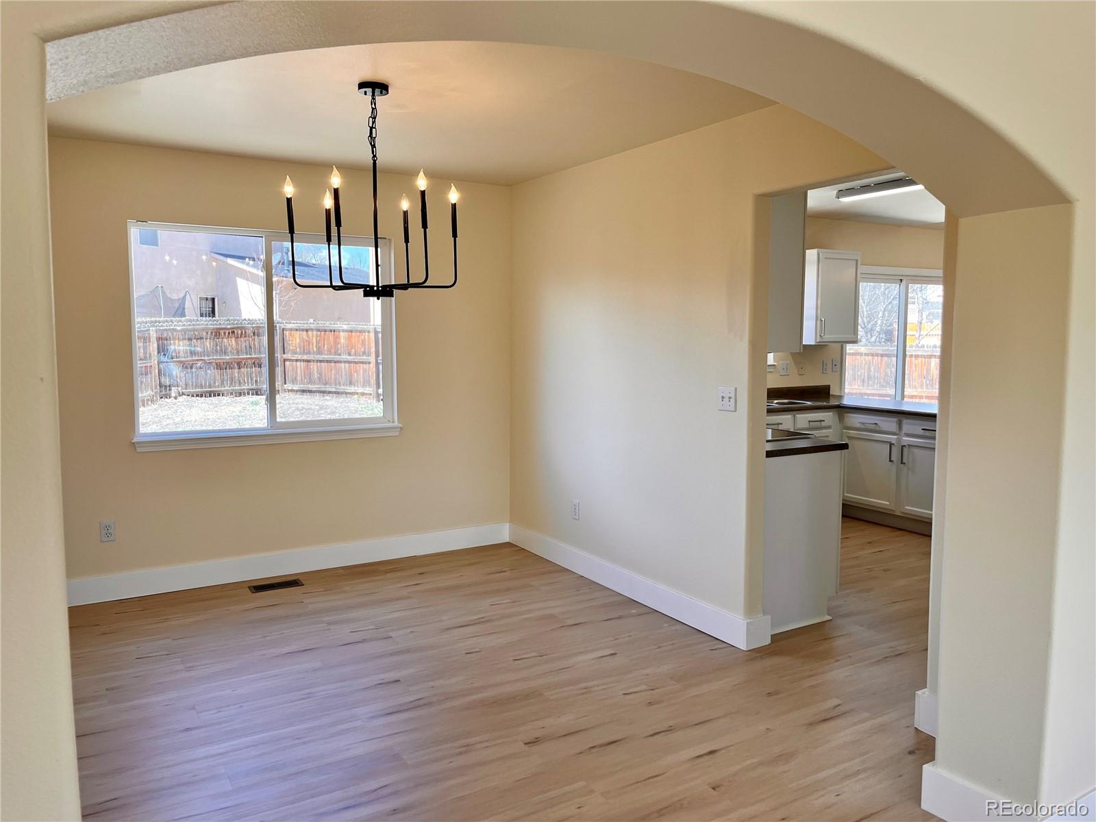 4660 Skylark Road Colorado Springs, CO 80916 - Photo 14 of 33 wooden floor in an empty room with a window