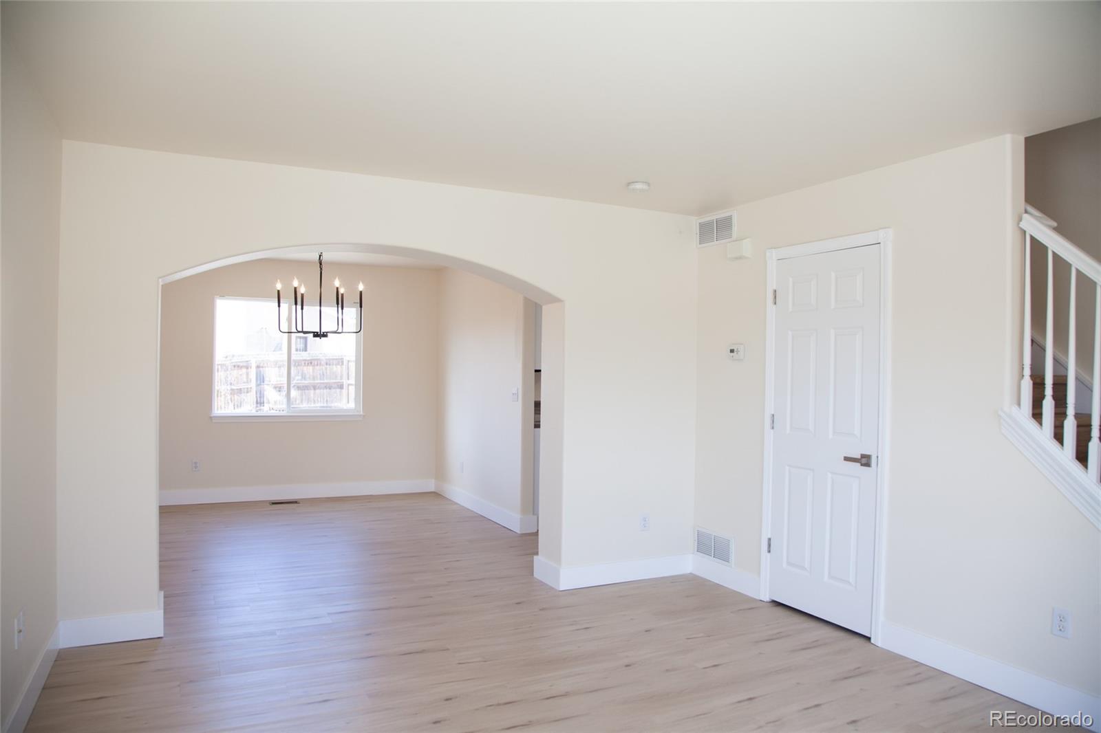 4660 Skylark Road Colorado Springs, CO 80916 - Photo 16 of 33 an empty room with wooden floor and windows