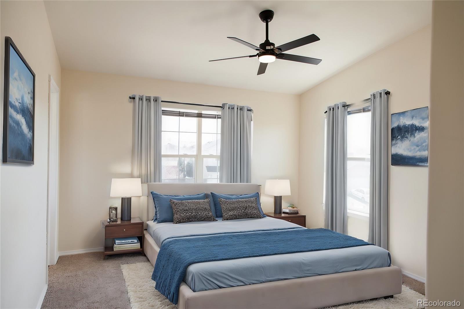 4660 Skylark Road Colorado Springs, CO 80916 - Photo 17 of 33 a bedroom with a large bed and a chandelier