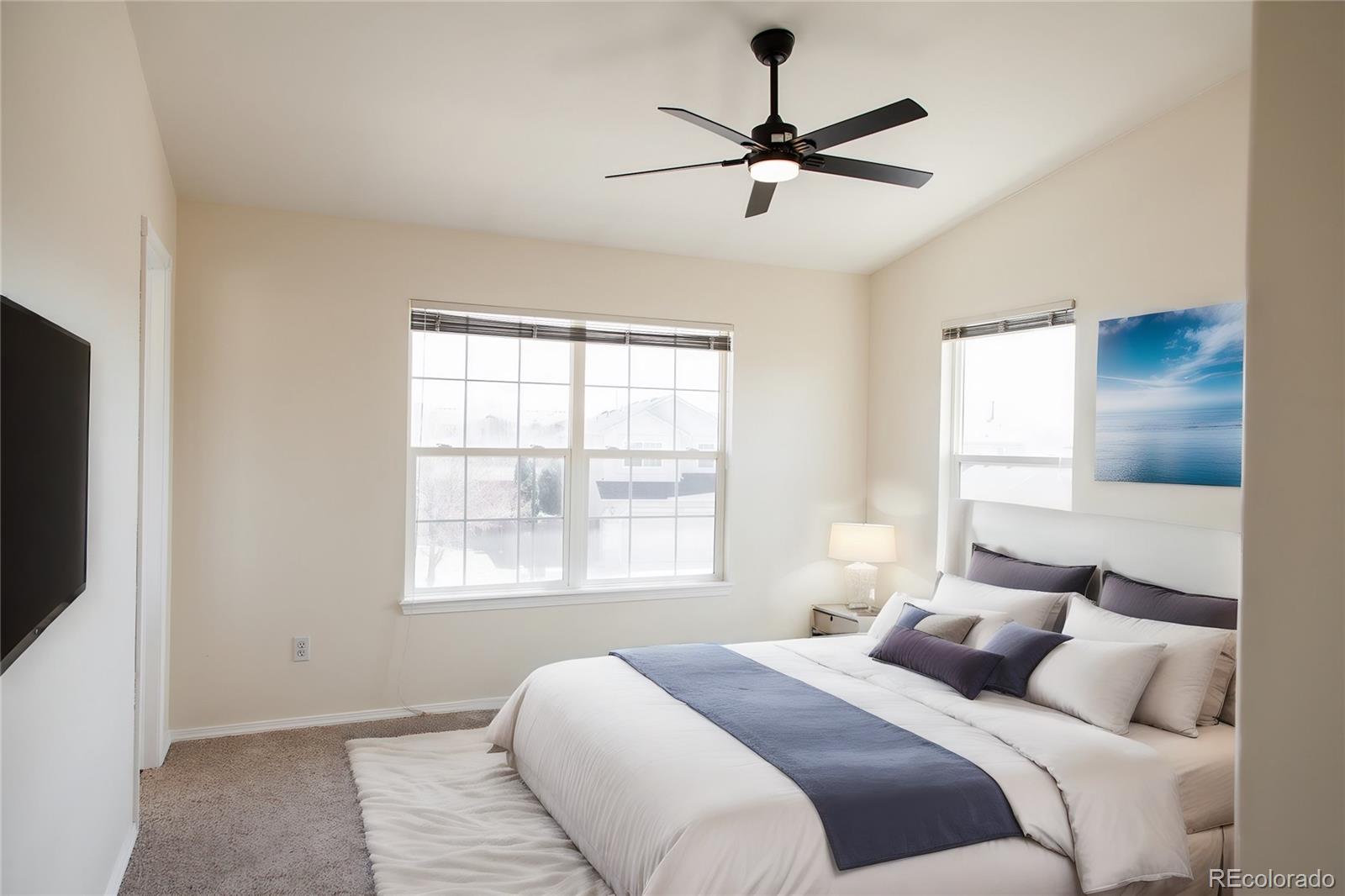 4660 Skylark Road Colorado Springs, CO 80916 - Photo 18 of 33 a bedroom with a large bed and a window