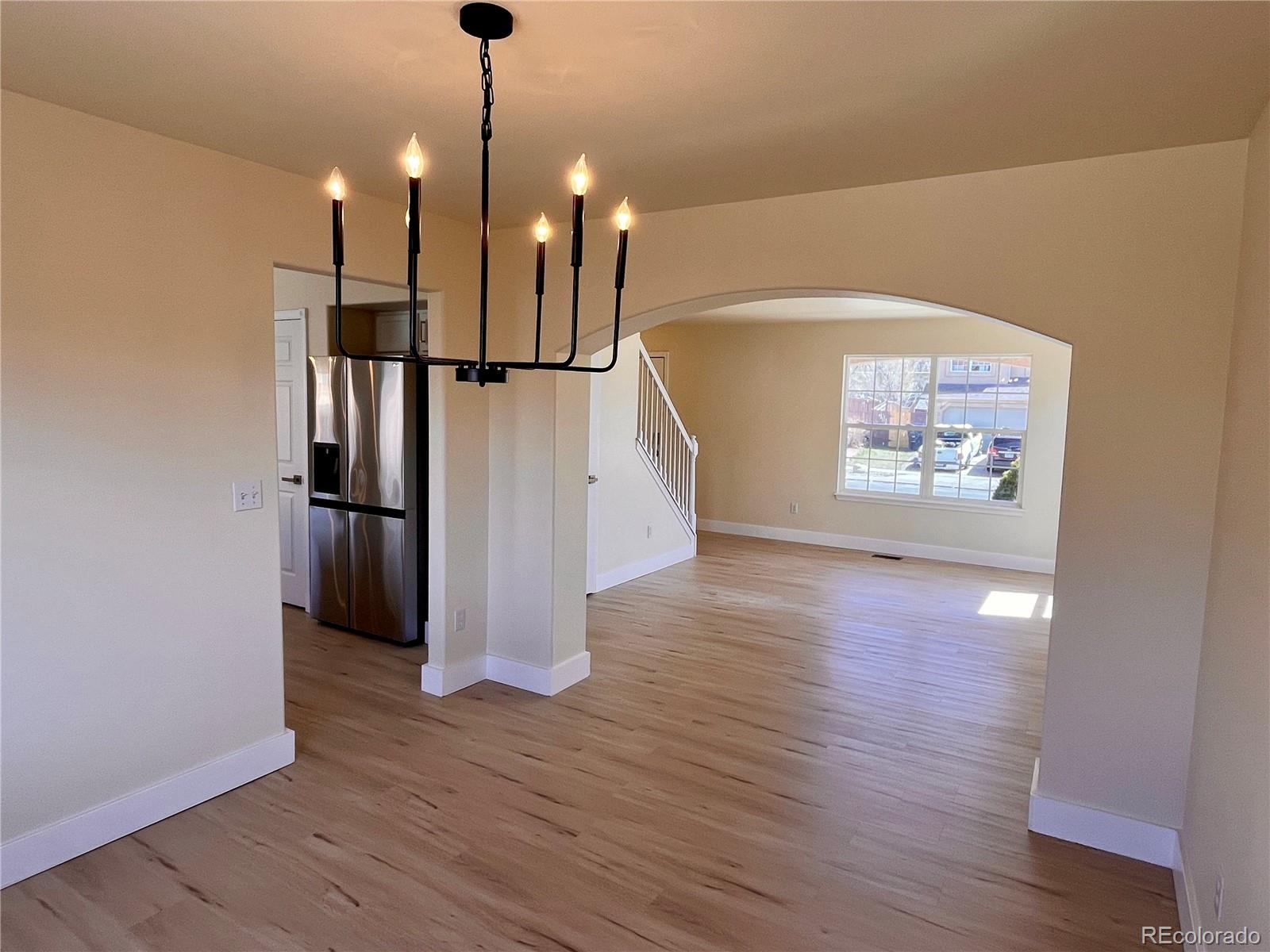 4660 Skylark Road Colorado Springs, CO 80916 - Photo 24 of 33 a view of a room with wooden floor staircase and a ceiling fan