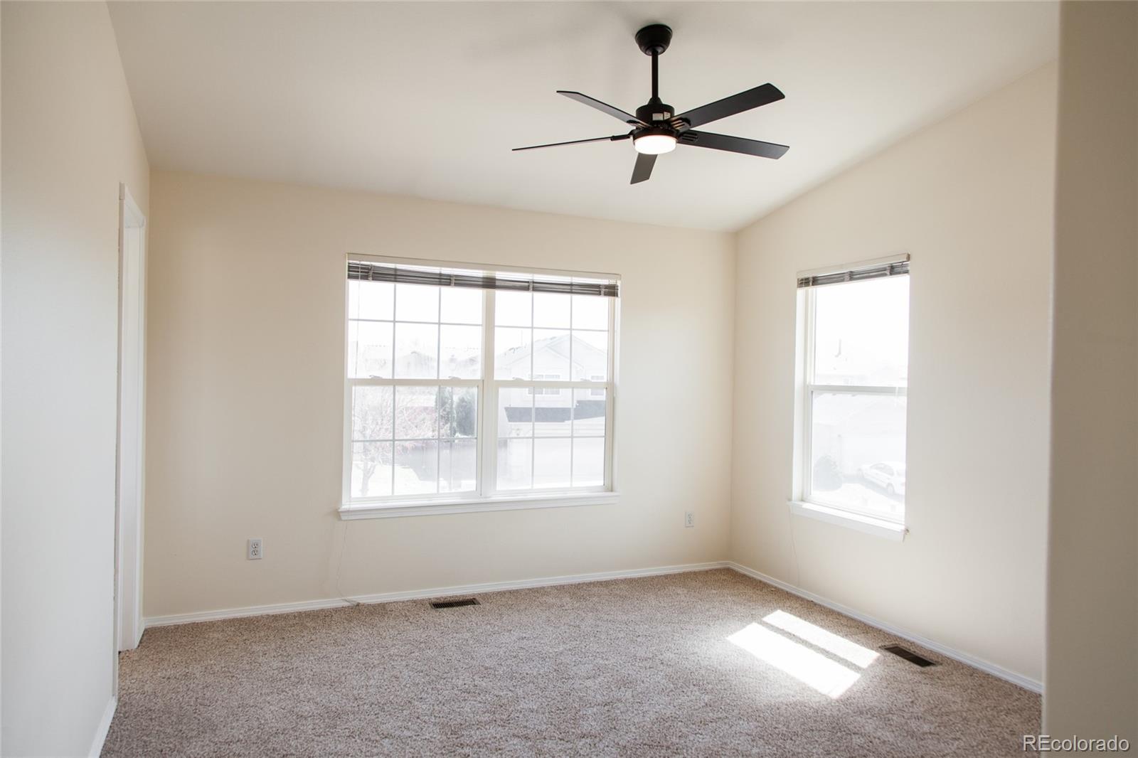 4660 Skylark Road Colorado Springs, CO 80916 - Photo 26 of 33 an empty room with windows and fan