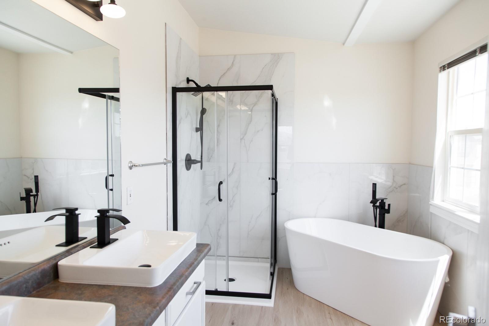 4660 Skylark Road Colorado Springs, CO 80916 - Photo 28 of 33 a bathroom with a tub sink and mirror