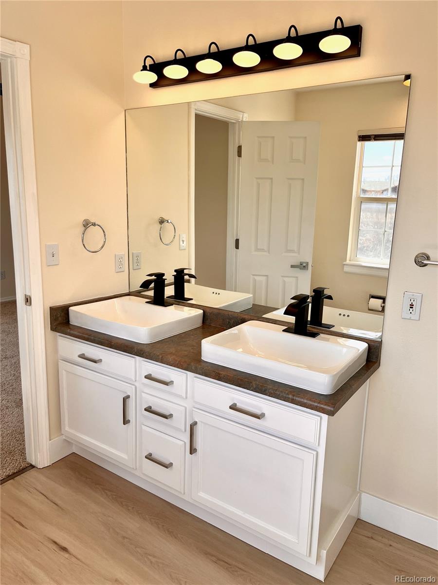 4660 Skylark Road Colorado Springs, CO 80916 - Photo 30 of 33 a bathroom with a sink and a mirror