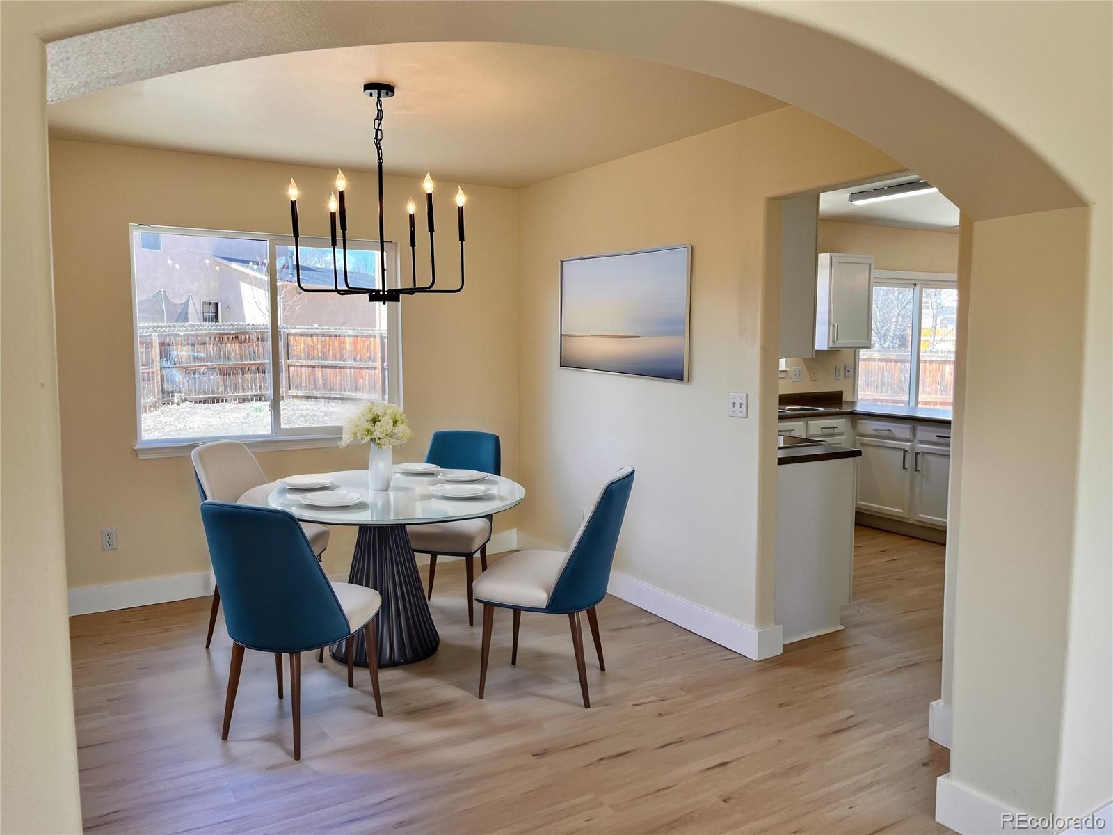 4660 Skylark Road Colorado Springs, CO 80916 - Photo 6 of 33 a view of a dining room with furniture and wooden floor