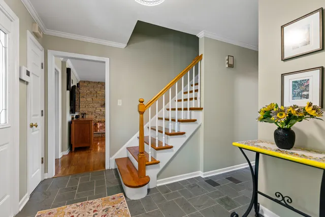 a view of an entryway with wooden floor and a livingroom