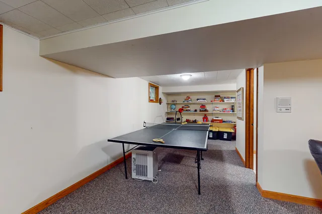 a living room with furniture a flat screen tv and a window