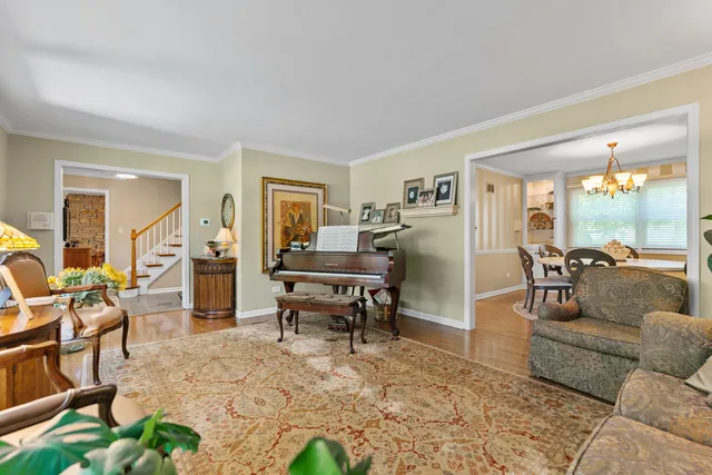 a living room with furniture and a dining table with kitchen view