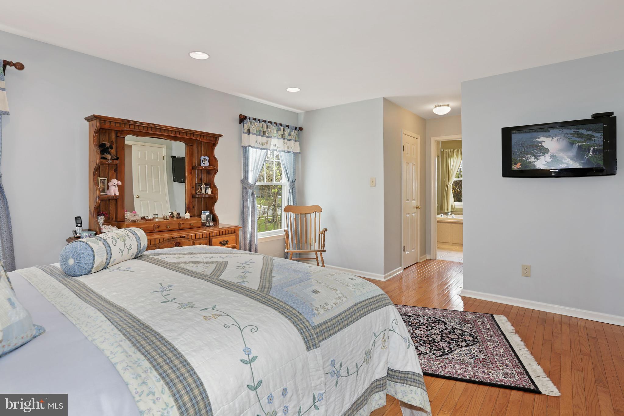 2 Burke Drive Medford, NJ 08055 - Photo 11 of 38 a bedroom with a bed a couch and a flat screen tv