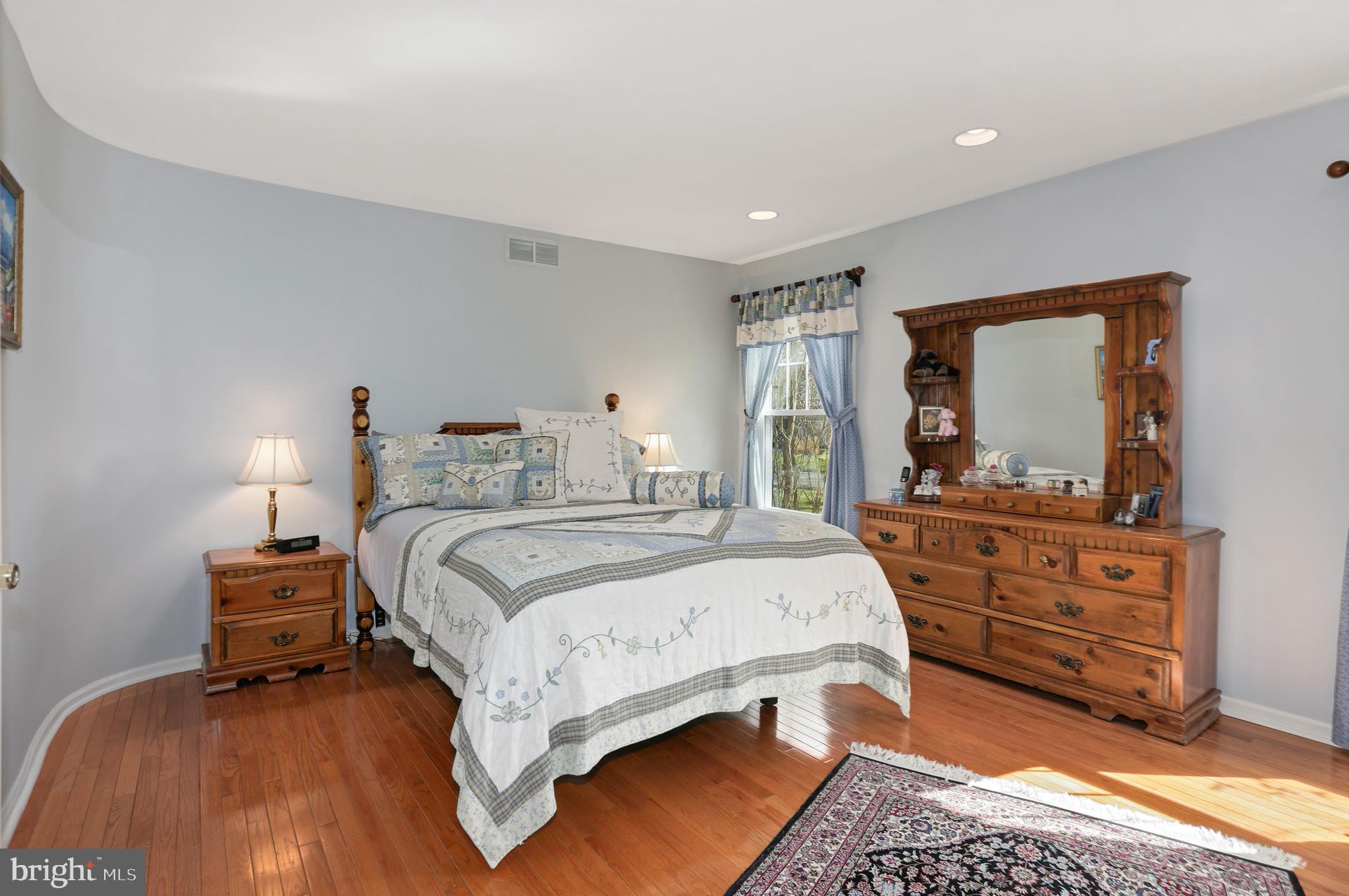2 Burke Drive Medford, NJ 08055 - Photo 10 of 38 a bedroom with a bed and a dresser with mirror