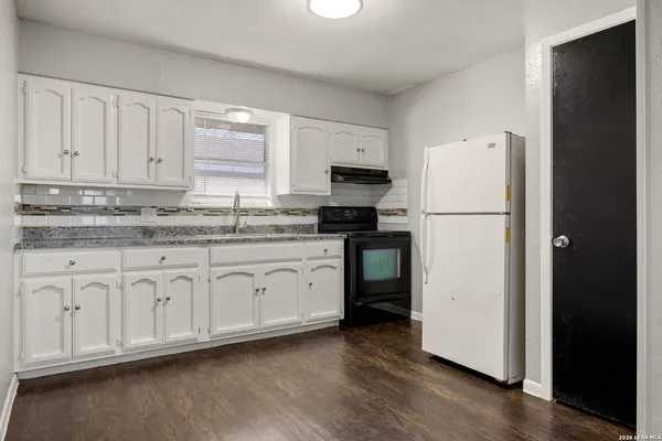 a kitchen with stainless steel appliances granite countertop a refrigerator sink and cabinets