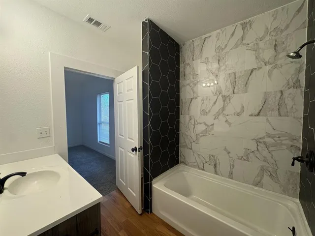 a bathroom with a sink and a bathtub
