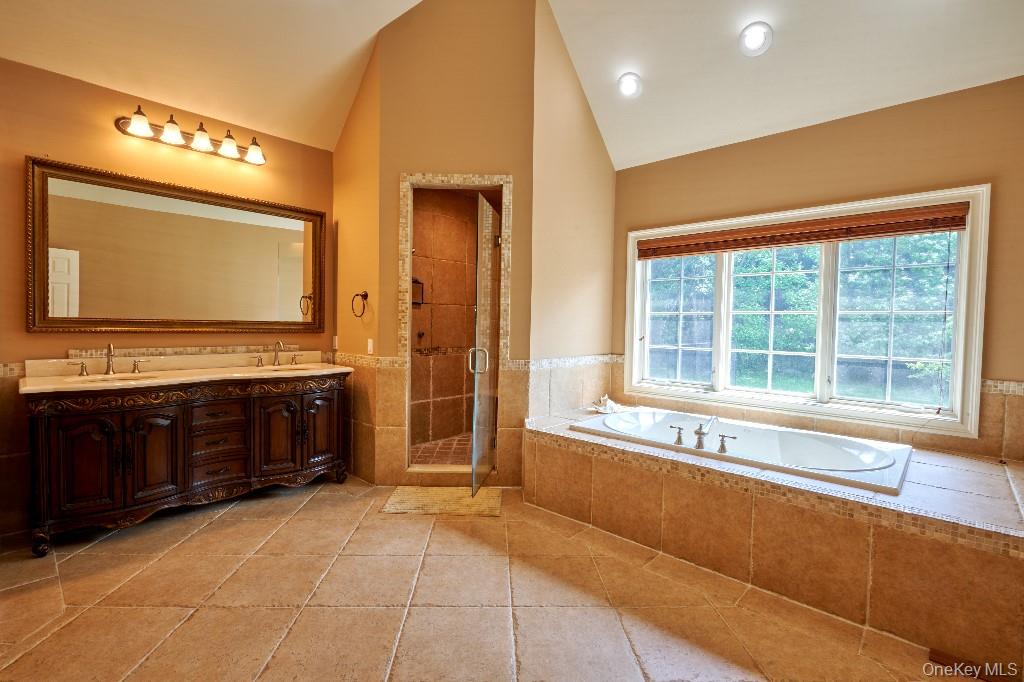 637 South Mountain Road New City, NY 10956 - Photo 25 of 36 a spacious bathroom with a large mirror vanity and bathtub