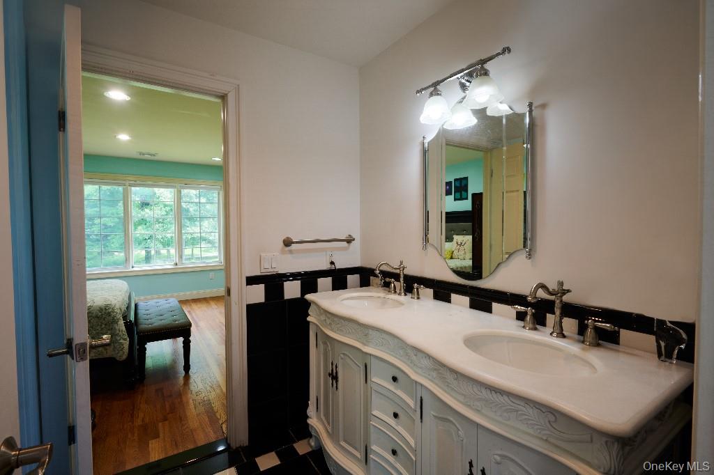 637 South Mountain Road New City, NY 10956 - Photo 32 of 36 a spacious bathroom with a double vanity sink and a mirror