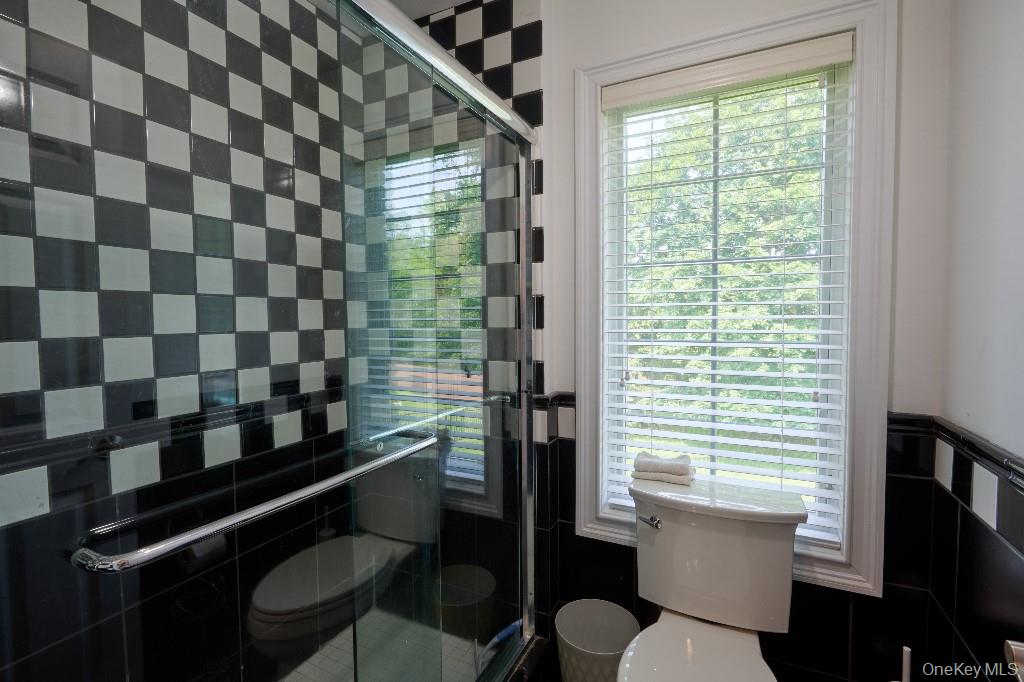 637 South Mountain Road New City, NY 10956 - Photo 33 of 36 a bathroom with a sink a toilet a window and shower
