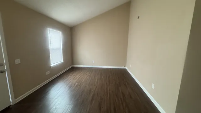 a view of an empty room and wooden floor