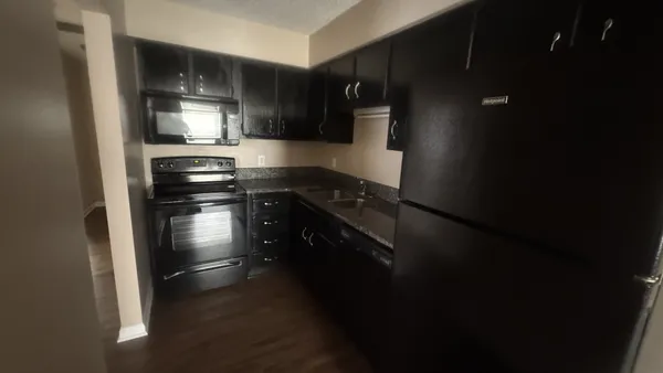 a kitchen with a sink and stainless steel appliances