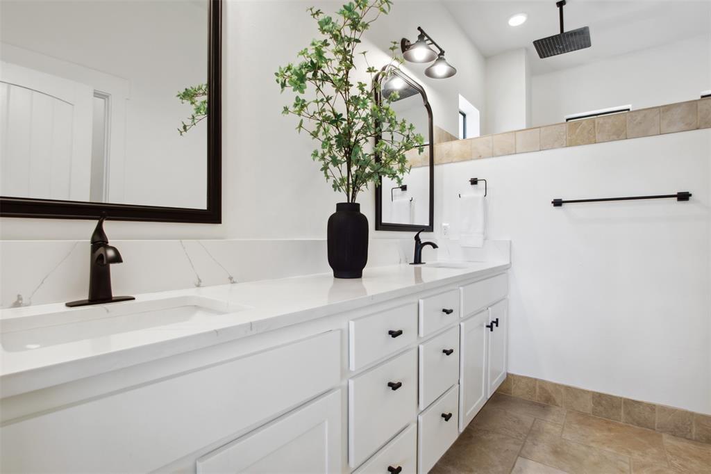 18852 Hidden Ridge Place Jonestown, TX 78645 - Photo 17 of 29 a bathroom with a double vanity sink and a mirror