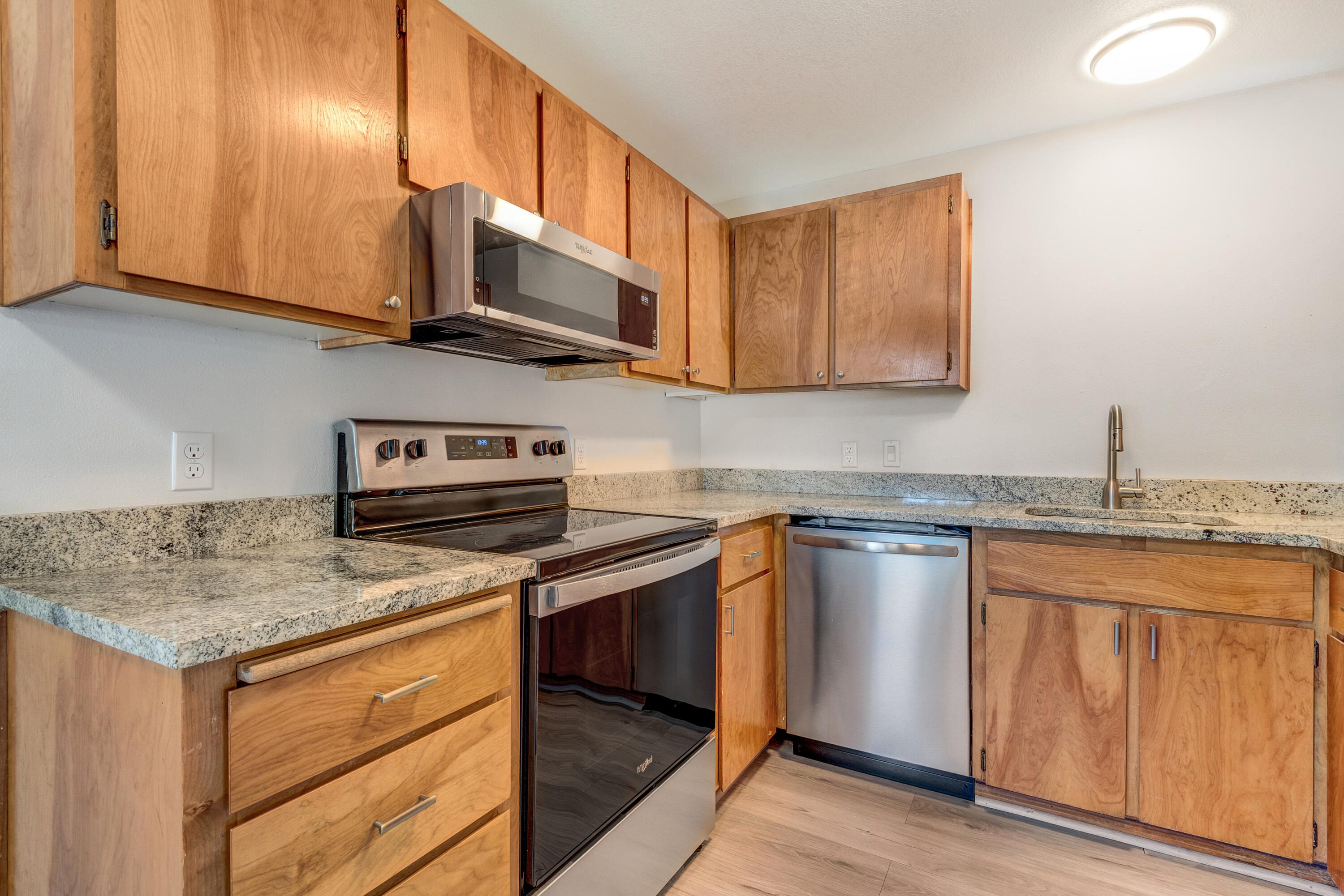 1916 Northeast Wichita Way Bend, OR 97701 - Photo 11 of 38 a kitchen with stainless steel appliances granite countertop a sink stove and microwave