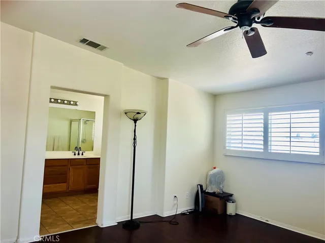 a view of a room with wooden floor and windows