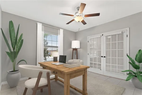 a living room with furniture a window and a potted plant