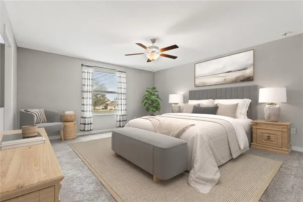 a spacious bedroom with a bed and ceiling fan