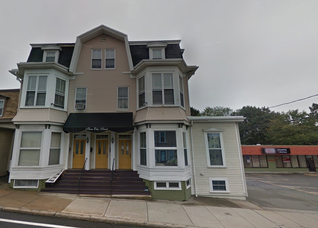 3 Elm Street, Unit 2 Framingham, MA 01701 - Photo 1 of 29 a front view of a residential apartment building with a yard