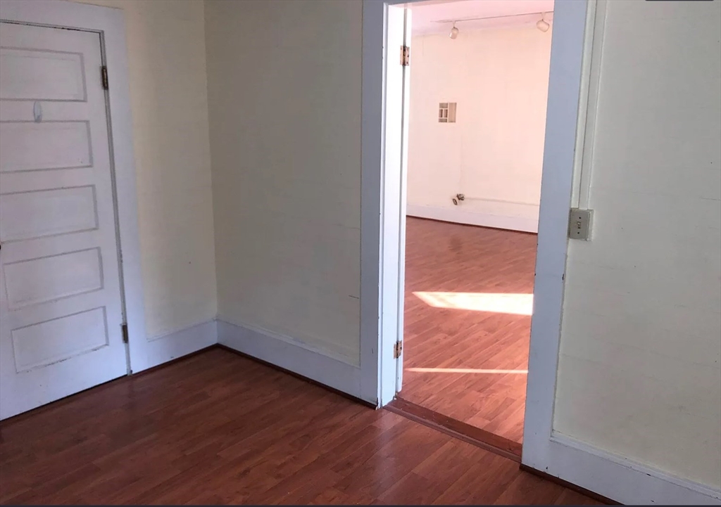 3 Elm Street, Unit 2 Framingham, MA 01701 - Photo 12 of 29 an empty room with wooden floor and windows