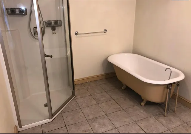 a bathroom with a glass shower door