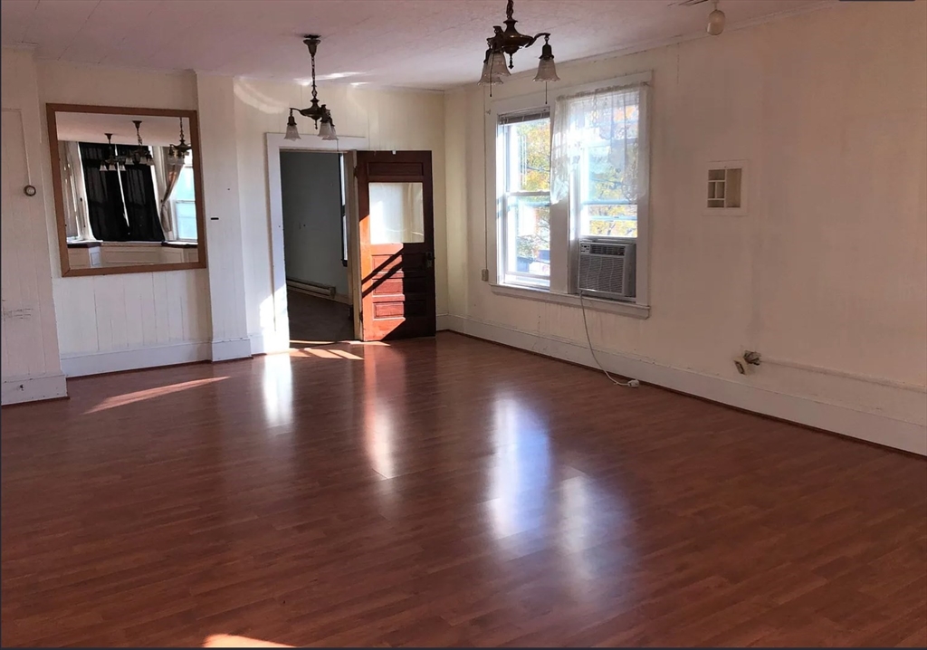 3 Elm Street, Unit 2 Framingham, MA 01701 - Photo 2 of 29 an empty room with wooden floor cabinet and windows
