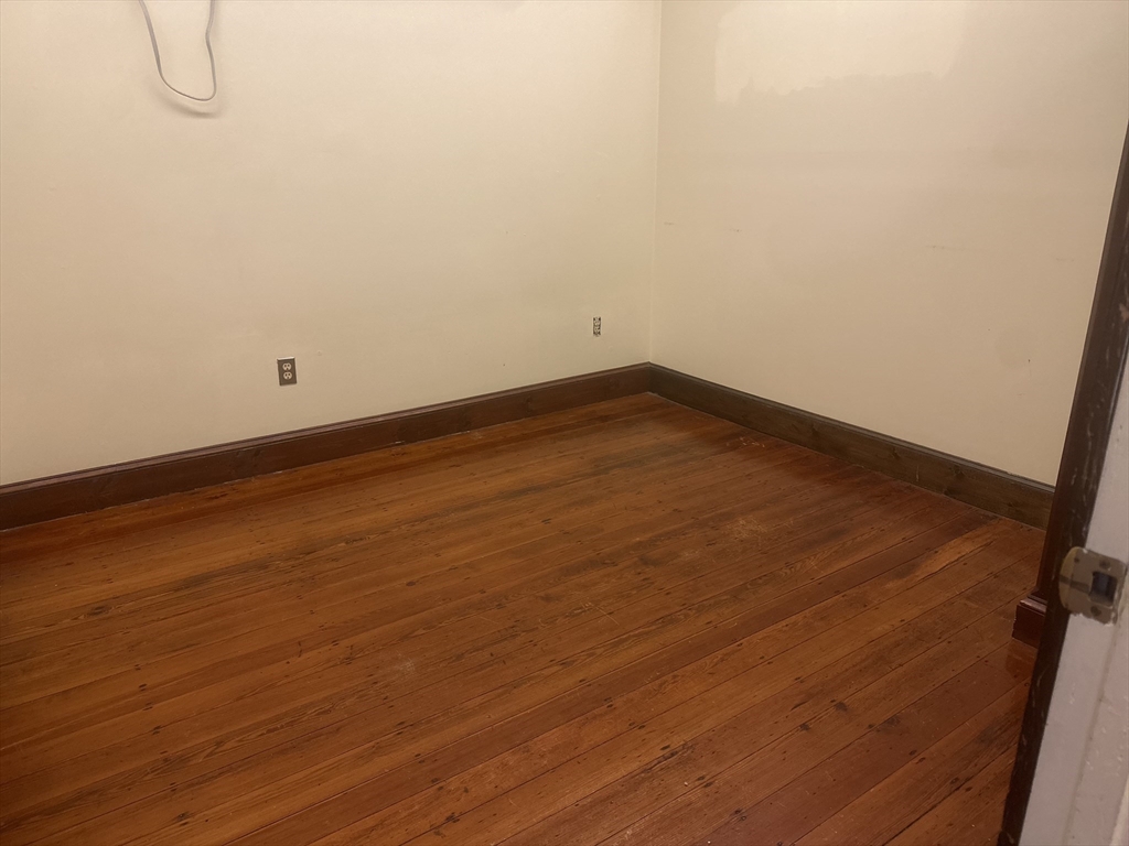 3 Elm Street, Unit 2 Framingham, MA 01701 - Photo 21 of 29 a view of a room with wooden floor and white walls