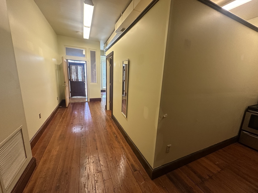 3 Elm Street, Unit 2 Framingham, MA 01701 - Photo 24 of 29 a view of a hallway with wooden floor and staircase