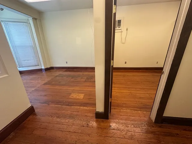 a view of a room with wooden floor