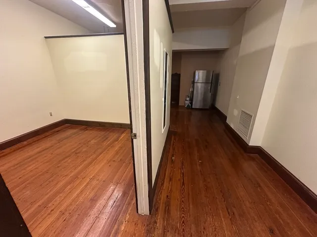 a view of room with wooden floor