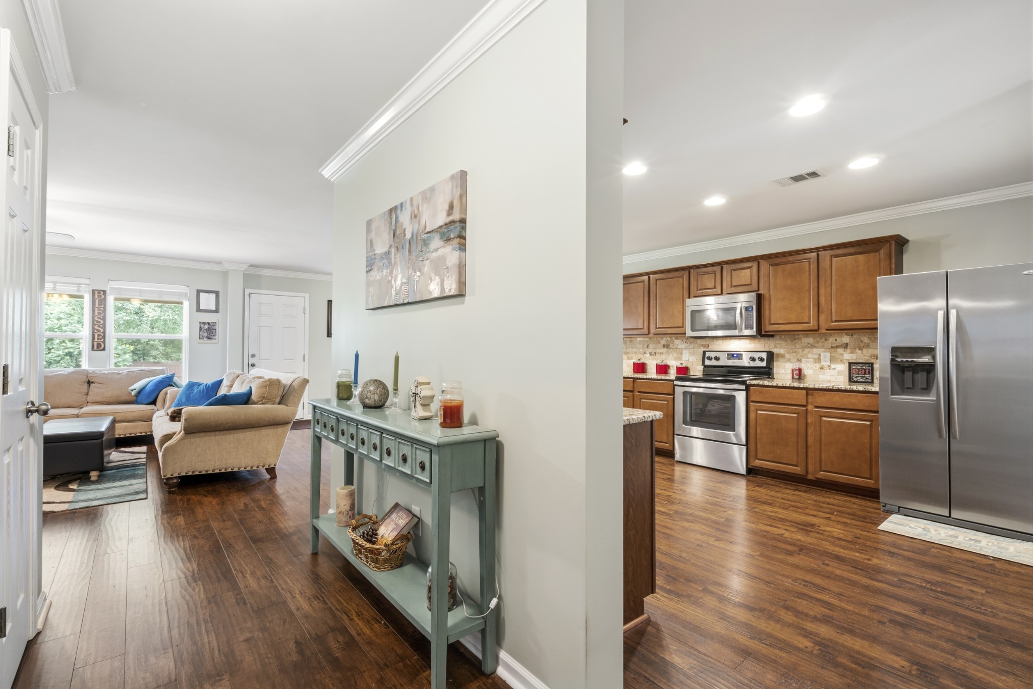 1011 Benwick Road Hendersonville, TN 37075 - Photo 18 of 60 a living room with stainless steel appliances furniture wooden floor and a kitchen view