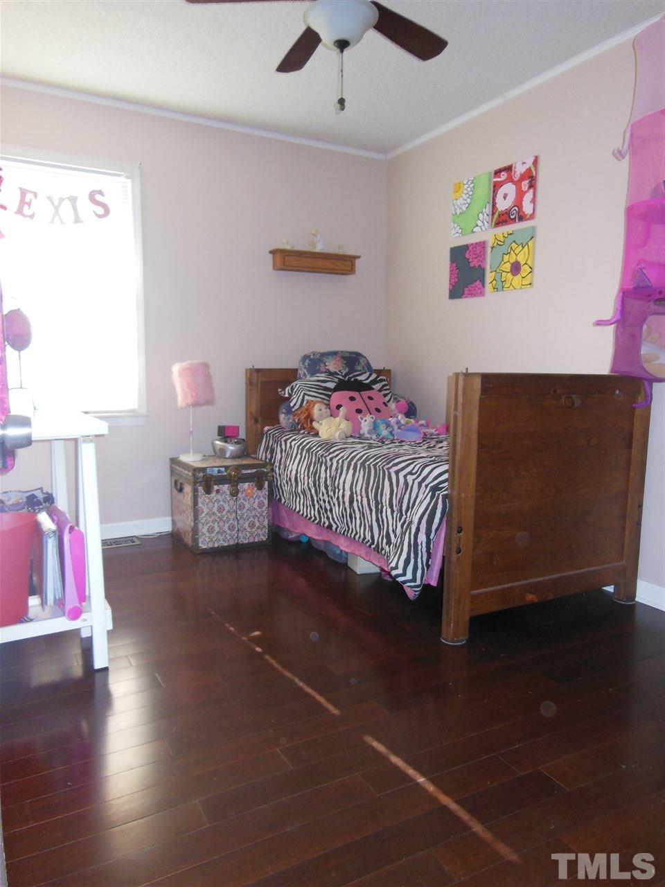 1125 Marlborough Road Raleigh, NC 27610 - Photo 11 of 23 a bedroom with a bed and a dresser