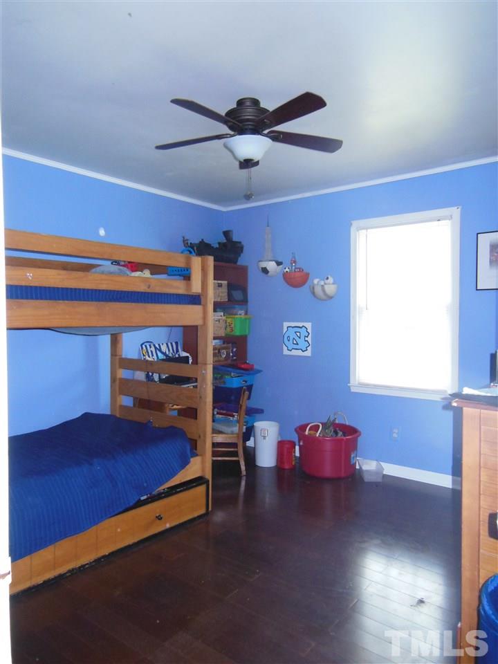 1125 Marlborough Road Raleigh, NC 27610 - Photo 12 of 23 a bedroom with a bed and a window